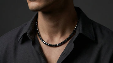 Close up of a male model wearing black moissanite tennis bracelett
