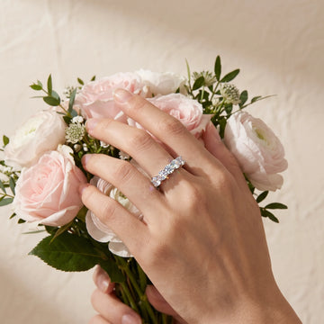 Bride wearing the 1.5ct five stone moissanite wedding band in white gold while holding a bouquet - Sensitive Stones