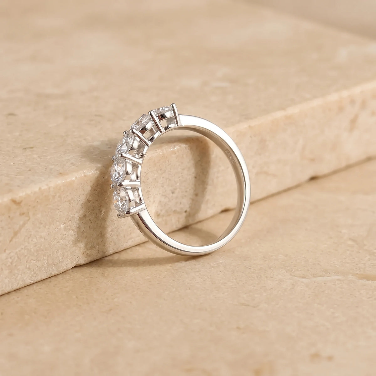 Side profile of the five stone moissanite wedding band in white gold showing the 4mm stones in shared prongs - Sensitive Stones