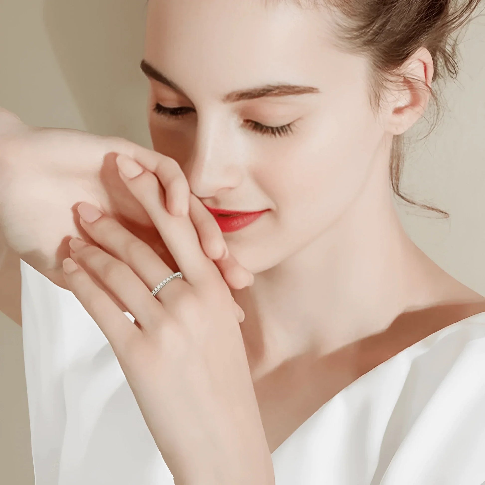 Close-up of a woman’s hand wearing a 1.86 CT moissanite eternity ring in 925 sterling silver, styled with a minimalist manicure.