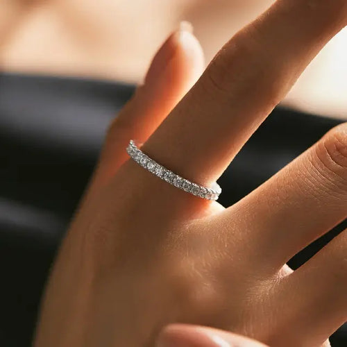 Soft portrait of a woman wearing a 1.86 CT moissanite sterling silver eternity band, styled with an effortless, elegant look.