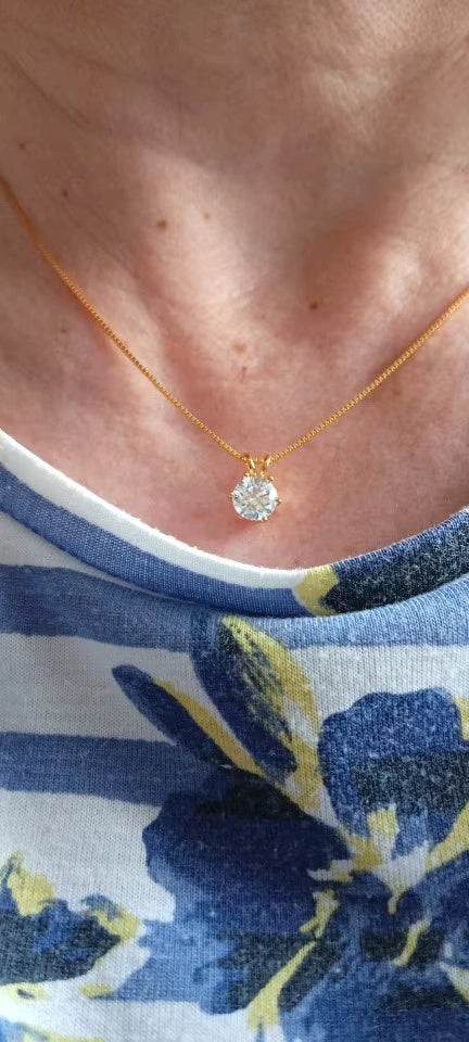 Close-up of a moissanite solitaire necklace in 18K gold-plated silver, highlighting the radiant sparkle of a women’s moissanite pendant, ideal for quiet luxury styling.