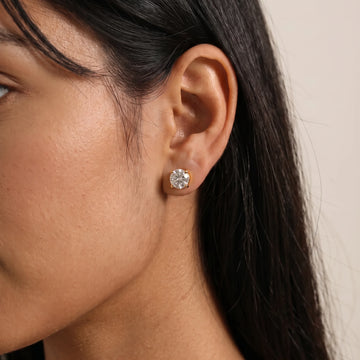 14K gold filled moissanite solitaire stud earring in yellow gold, round brilliant D color VVS1 worn on the ear - Sensitive Stones