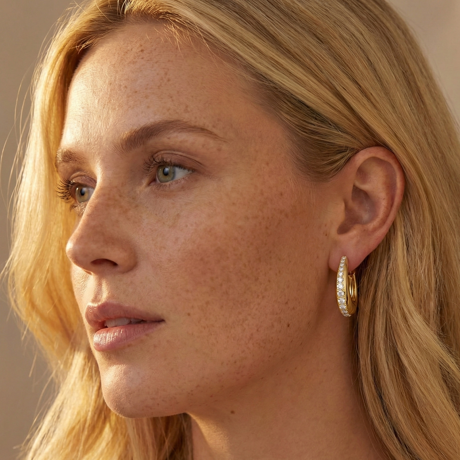 Close up of a woman wearing 14K gold filled moissanite chunky hoop earrings  bold pavé style, warm lighting - Sensitive Stones