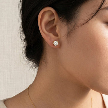 14K gold filled moissanite solitaire stud earring in yellow gold, 2ct round brilliant D color VVS1, worn on ear - Sensitive Stones