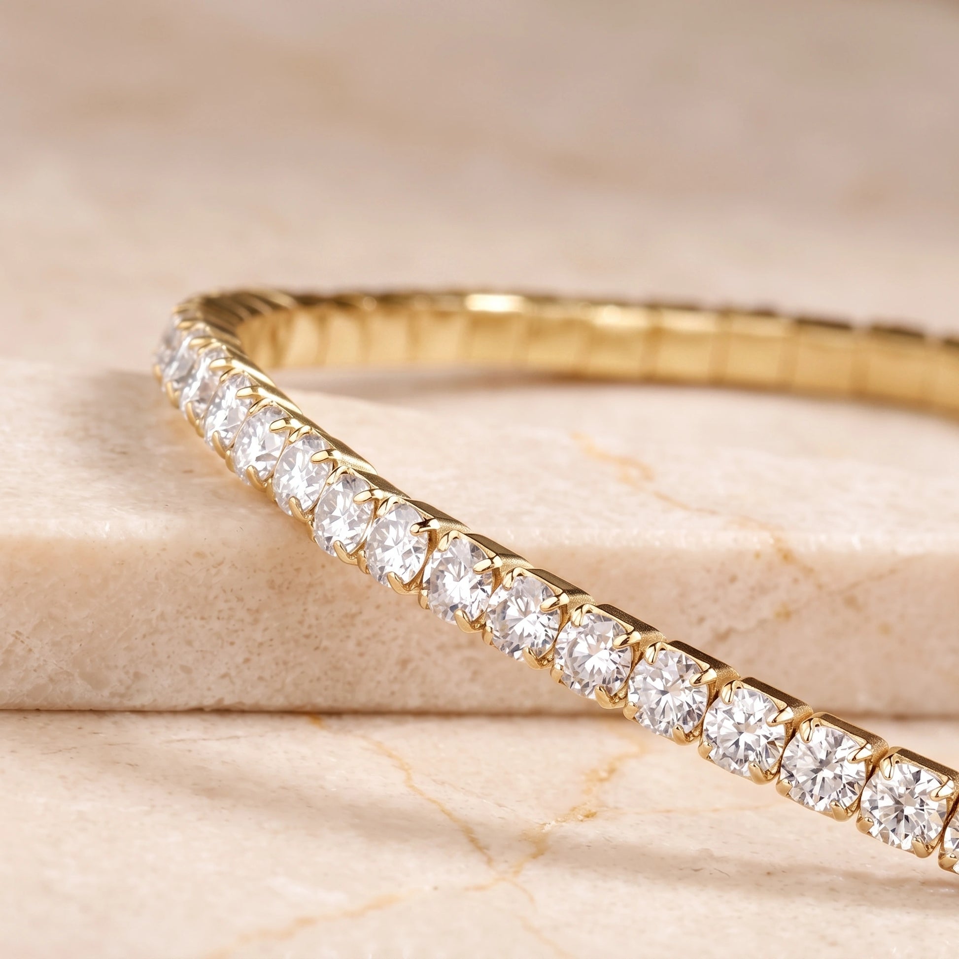Close-up of round D color VVS1 moissanite stones in a 14K gold filled stretch tennis bracelet