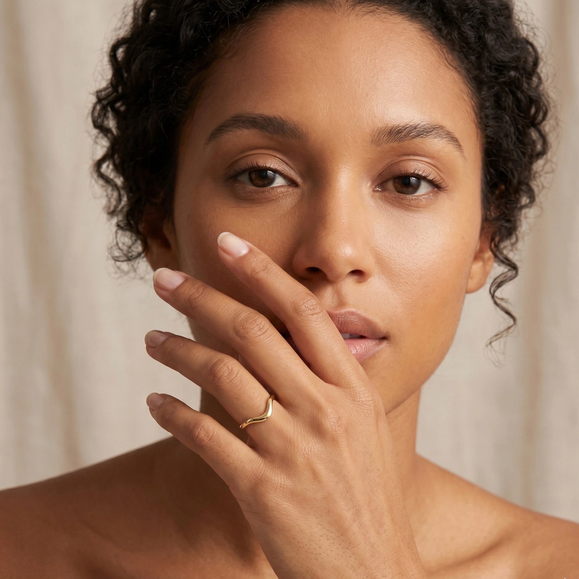 14K gold filled wave ring worn solo on model's finger showing slim asymmetric profile - Sensitive Stones