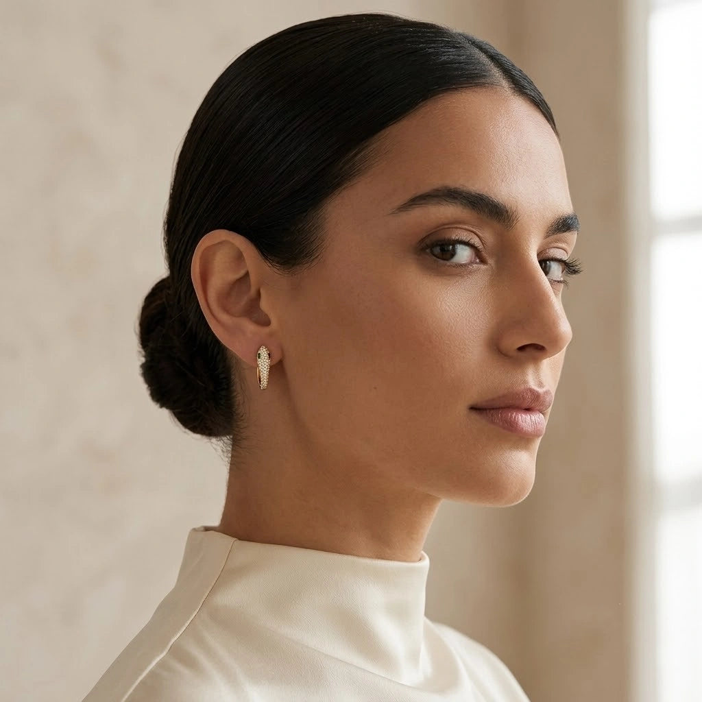 Woman wearing 18k gold plated moissanite snake hoop earrings against a neutral background - Sensitive Stones