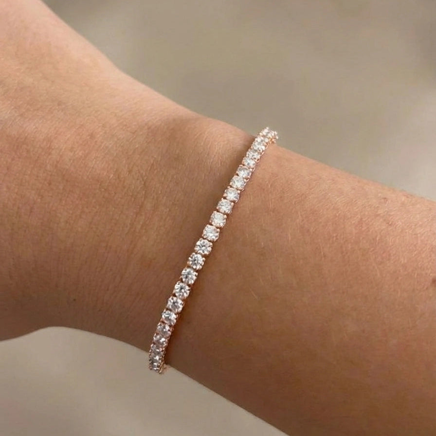 Hand wearing 2.5mm elastic stretch rope moissanite tennis bracelet set in 925 silver with rose gold plating - Sensitive Stones