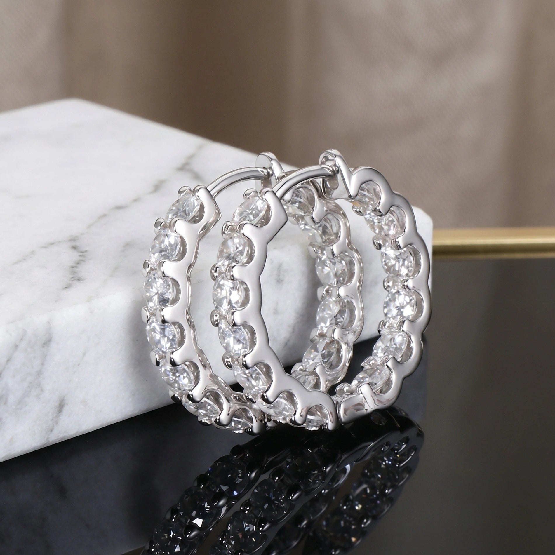 Close-up of 2.6 CT moissanite small hoop earrings in 18K white gold plated S925 silver, showcasing full front sparkle against black textured background.