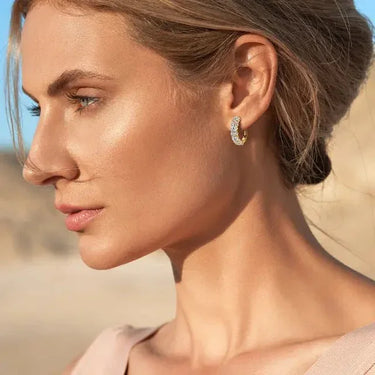 Woman wearing gold moissanite small hoop earrings, outdoor lifestyle close-up – Sensitive Stones