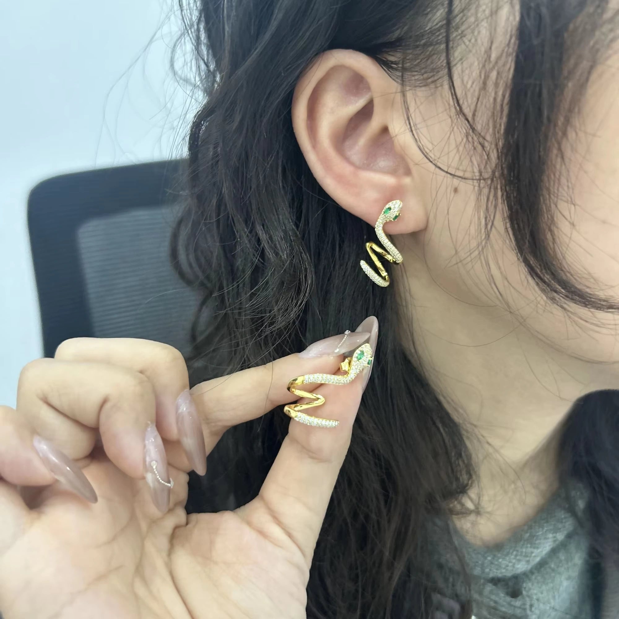 Woman showcasing a single moissanite snake ear climber earring, crafted in 18K yellow gold-plated sterling silver.