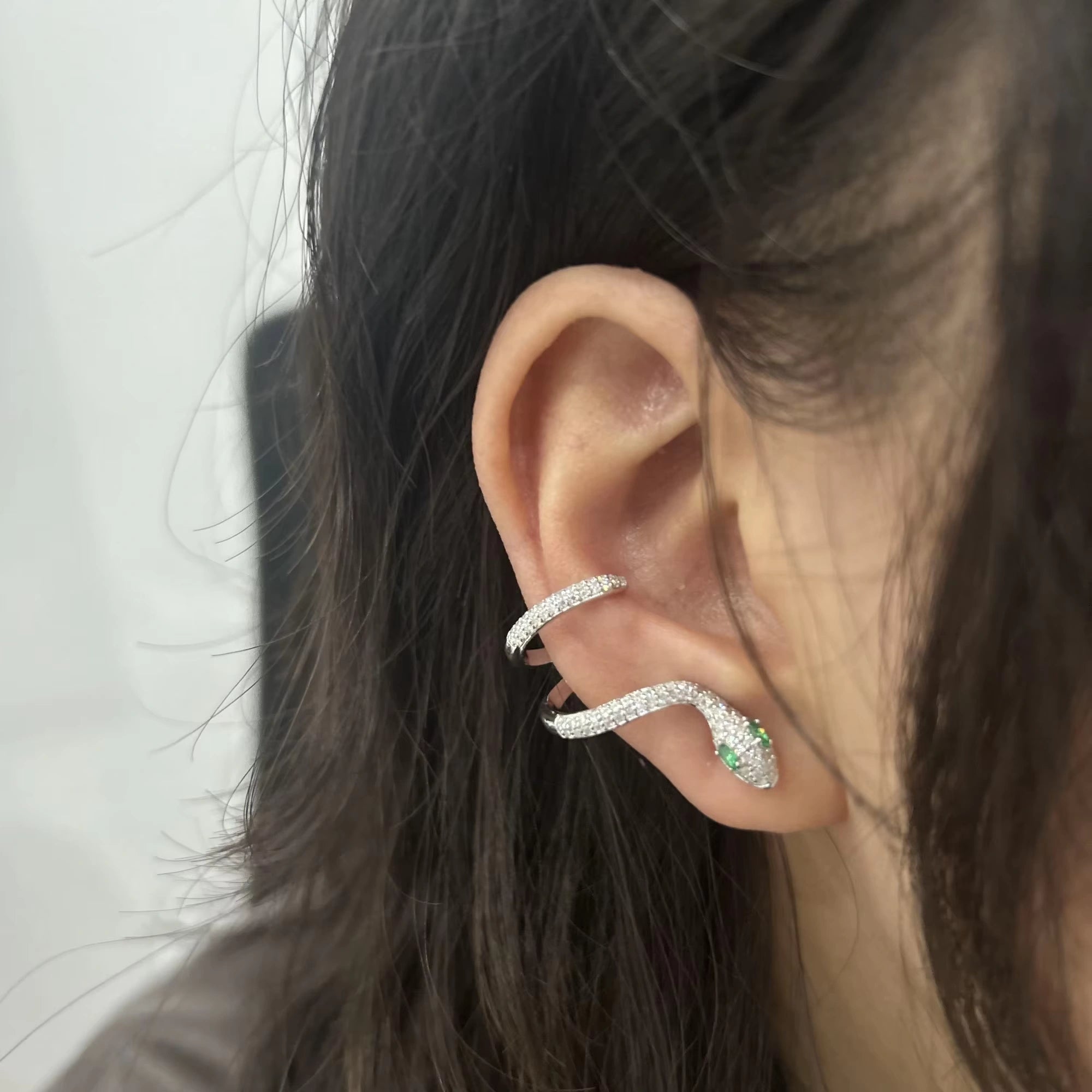 Elegant moissanite snake ear climber earring wrapping along the ear, crafted in 18K white gold over sterling silver.