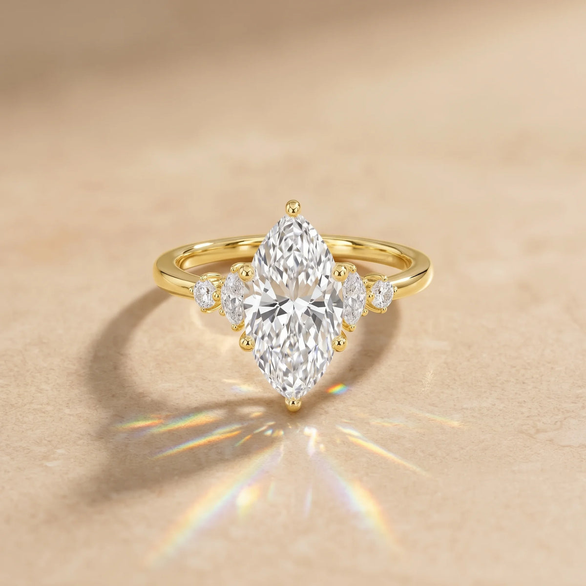 2ct marquise moissanite engagement ring in 14K gold filled throwing rainbow fire on a stone surface