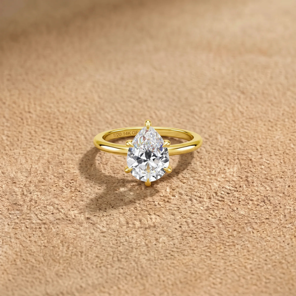 2ct pear cut moissanite engagement ring in 14K gold filled seen at an angle, showing the tapered point of the stone - Sensitive Stones