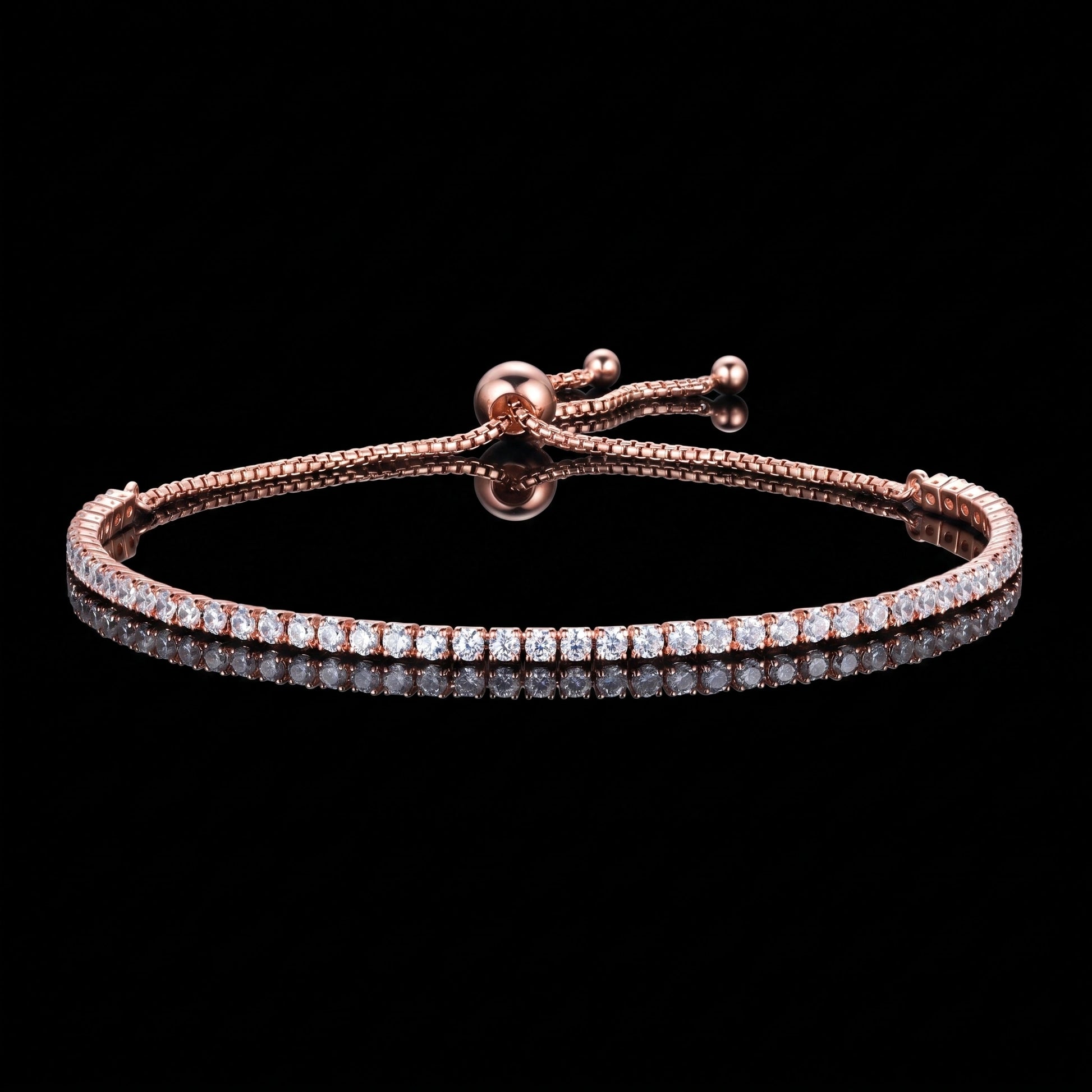 A 2mm moissanite bolo tennis bracelet with clear round-cut stones in 925 sterling silver with a rose gold finish and sliding bolo closure, on a reflective black background - Sensitive Stones