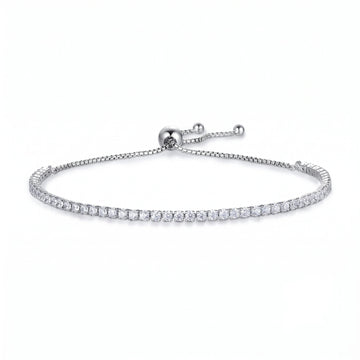 A white gold 2mm moissanite bolo tennis bracelet in 925 sterling silver on a white background, full edge-to-edge round stone setting - Sensitive Stones