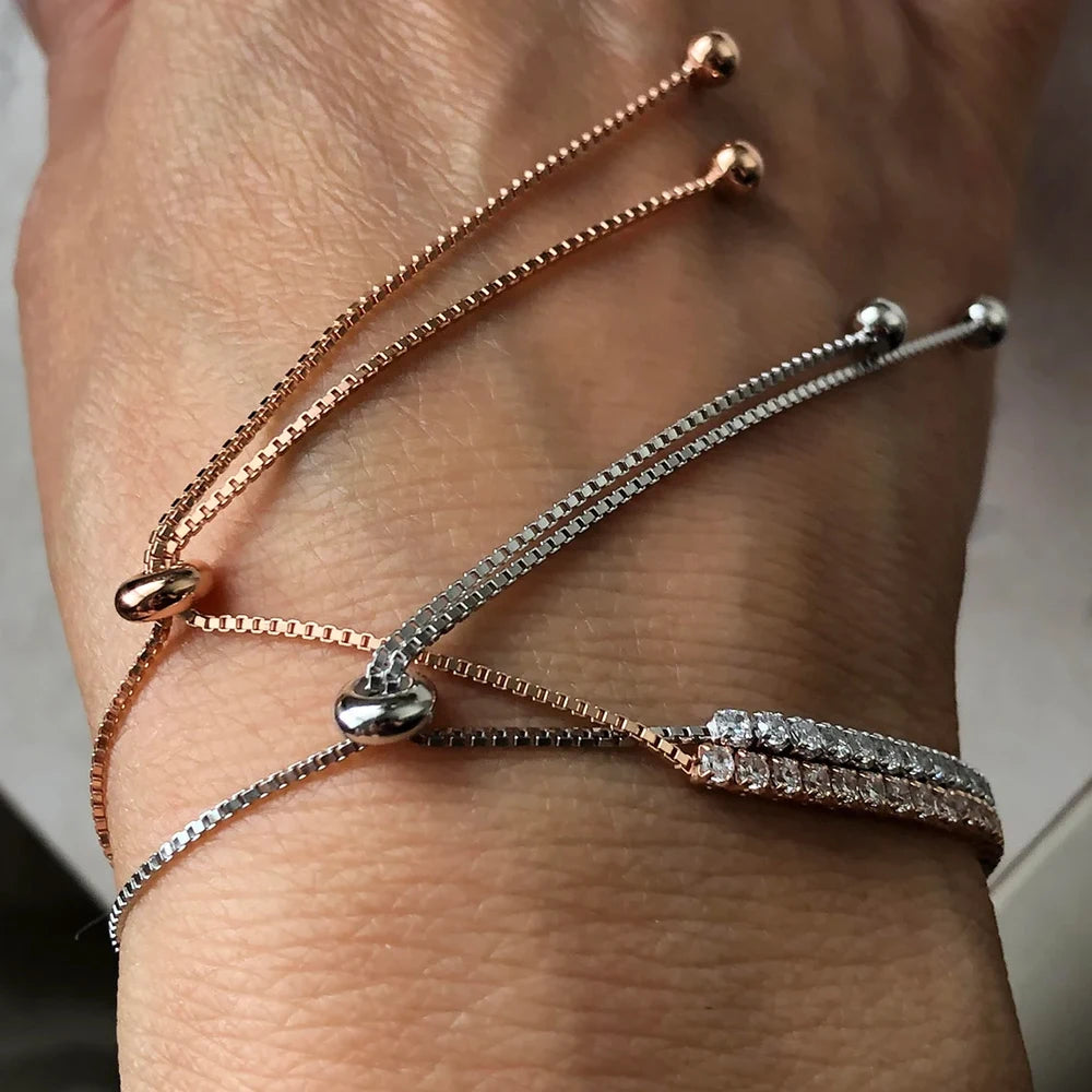 2mm moissanite bolo tennis bracelet in rose gold and silver worn on wrist showing adjustable sliding closure - Sensitive Stones