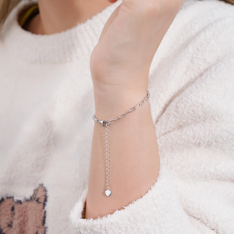 Dainty 2mm hybrid moissanite tennis bracelet with paperclip link in 18K white gold plating, featuring adjustable chain and sparkling VVS1 stones.