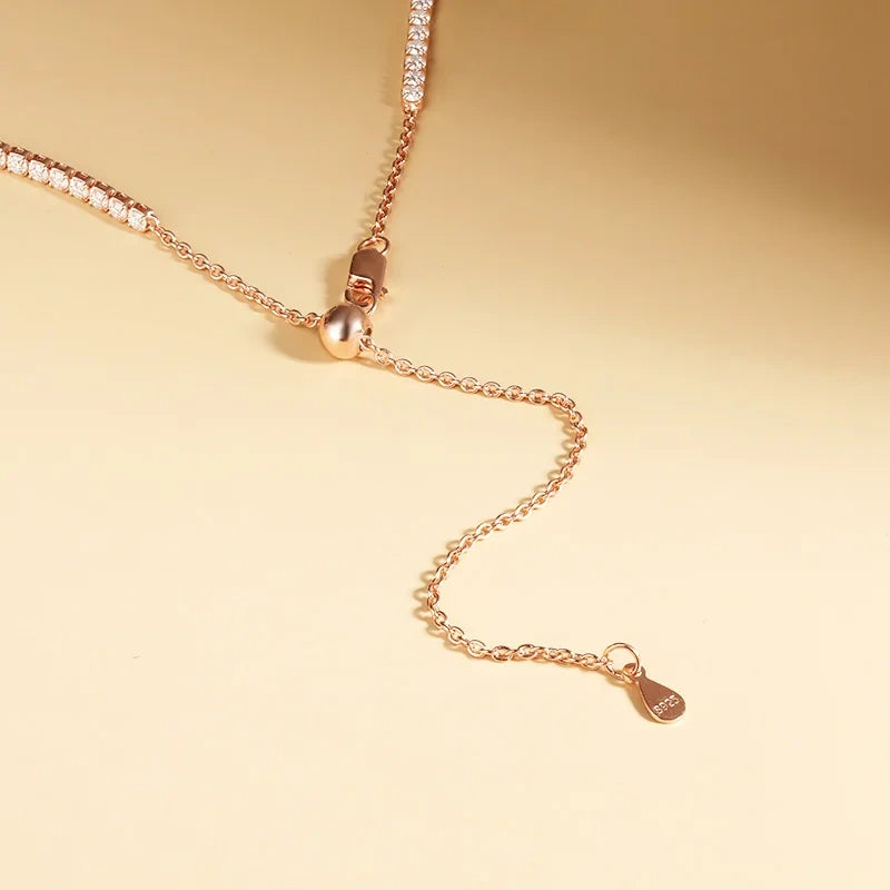 Close up of positioning bead and lobster clasp on 2mm moissanite tennis choker necklace in 18K rose gold plating - Sensitive Stones