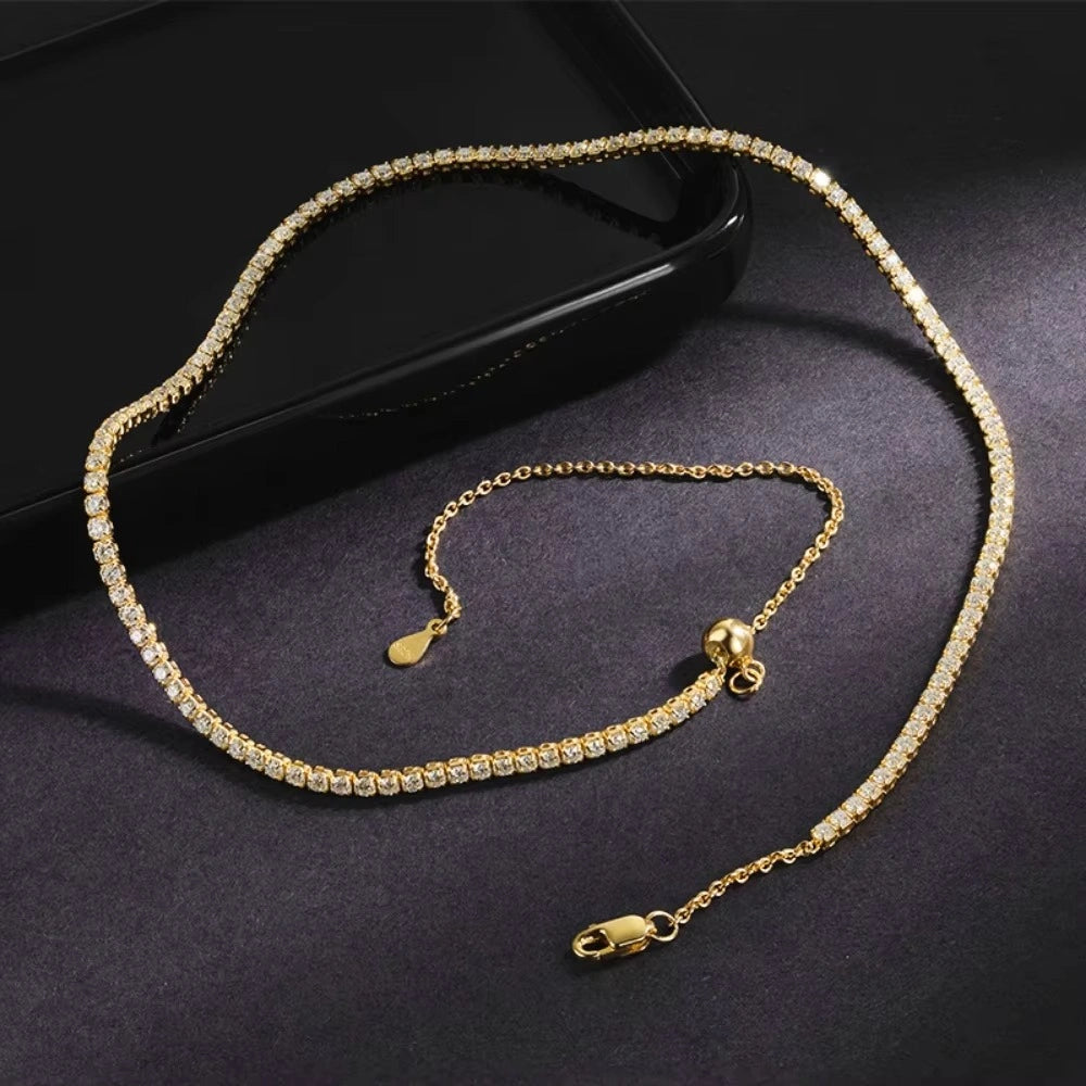 2mm moissanite tennis choker necklace in 18K yellow gold plating laid flat on black surface showing full length - Sensitive Stones