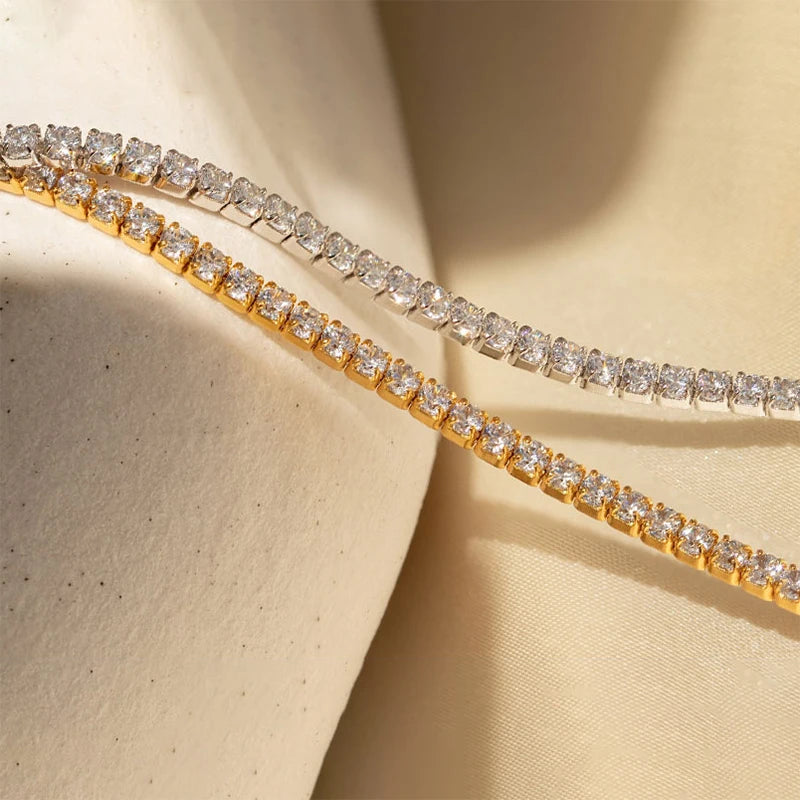 2mm moissanite tennis choker necklace in yellow gold and white gold finish side by side on fabric surface - Sensitive Stones