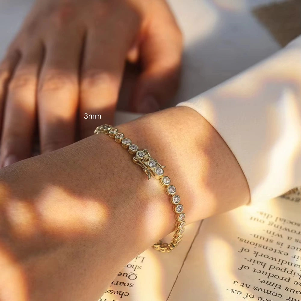 3mm full bezel set D color VVS1 moissanite tennis bracelet in 18K yellow gold plating on wrist, box clasp visible - Sensitive Stones