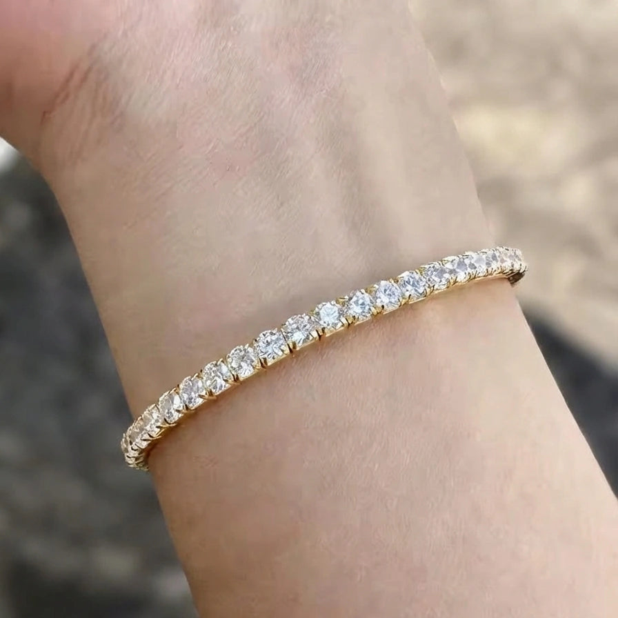 Hand wearing 3mm elastic stretch rope moissanite tennis bracelet set in 925 silver with yellow gold plating - Sensitive Stones
