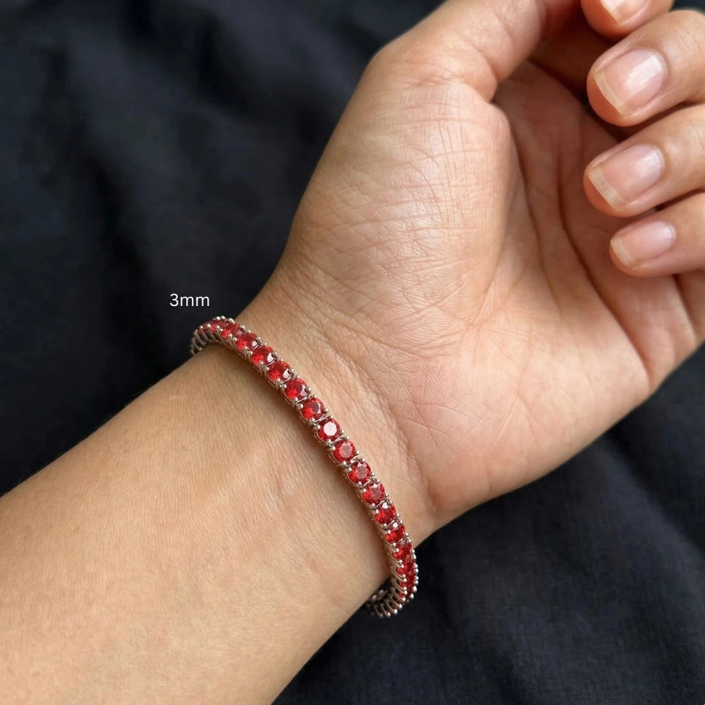 3mm red moissanite tennis bracelet in sterling silver on female wrist with black background - Sensitive Stones