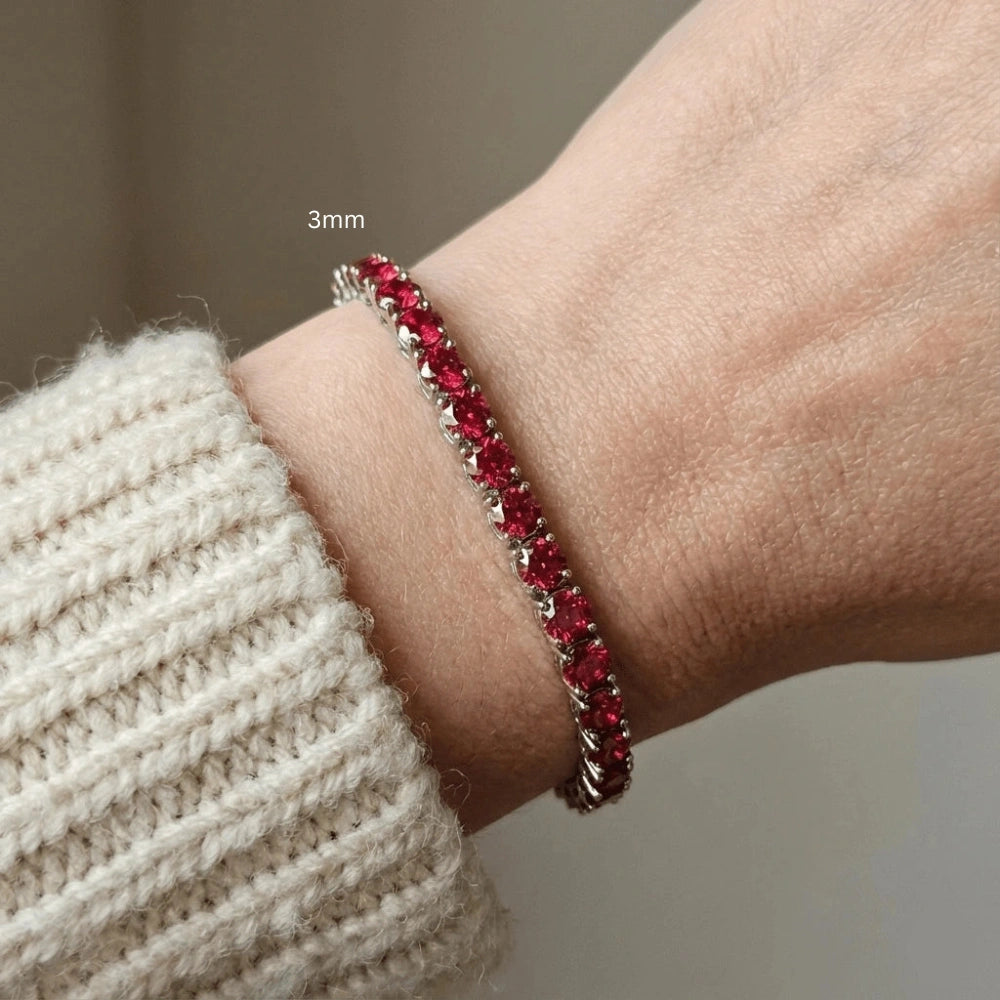 3mm red moissanite tennis bracelet with flame-lit brilliance worn with cozy cream sweater, showcasing everyday elegance in sterling silver with white gold plating - Sensitive Stones