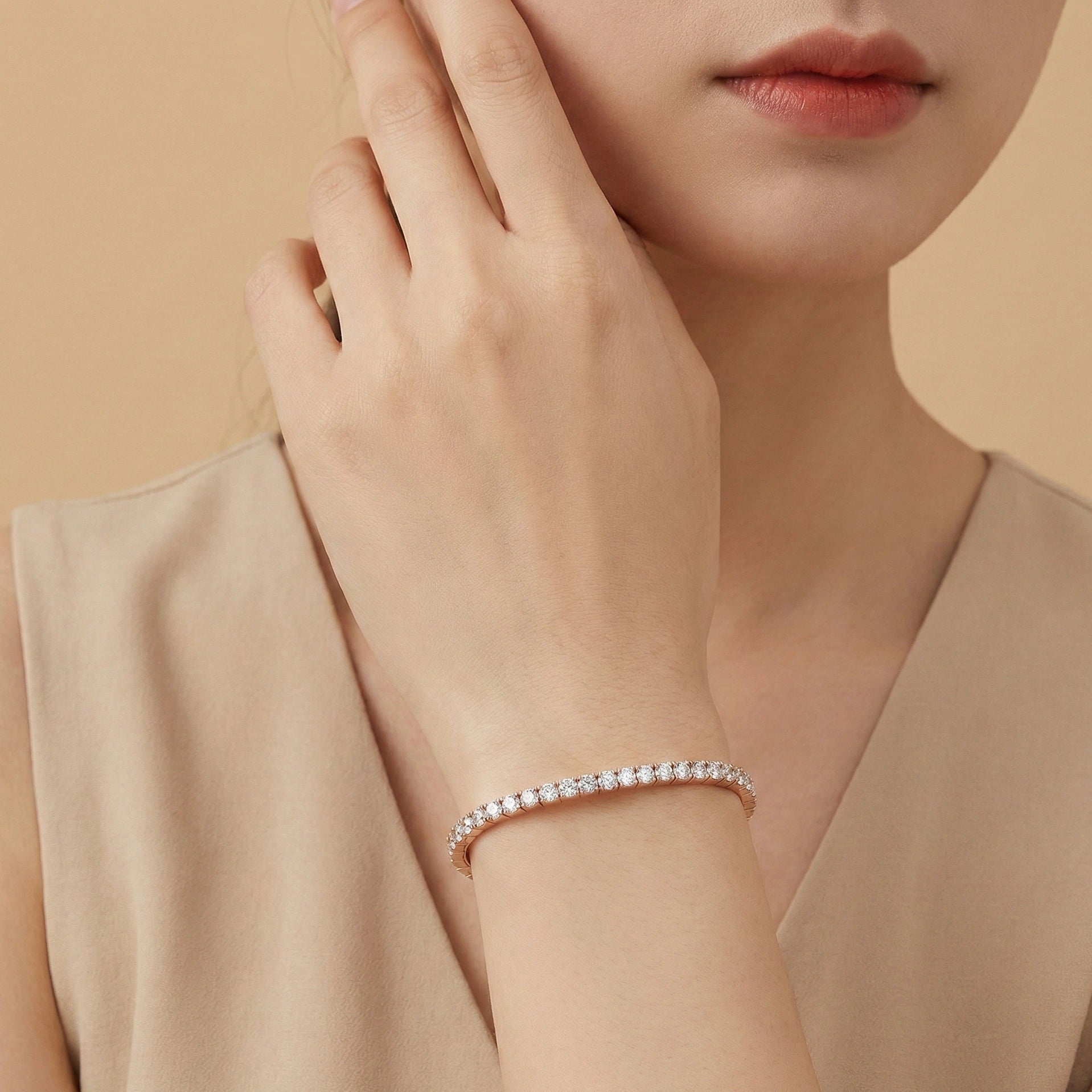 Woman styling a 3mm rose gold elastic moissanite tennis bangle bracelet on wrist for a refined minimalist look - Sensitive Stones