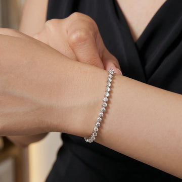 3mm 3-prong moissanite tennis bracelet in 925 sterling silver worn on the wrist, arm across the body - Sensitive Stones