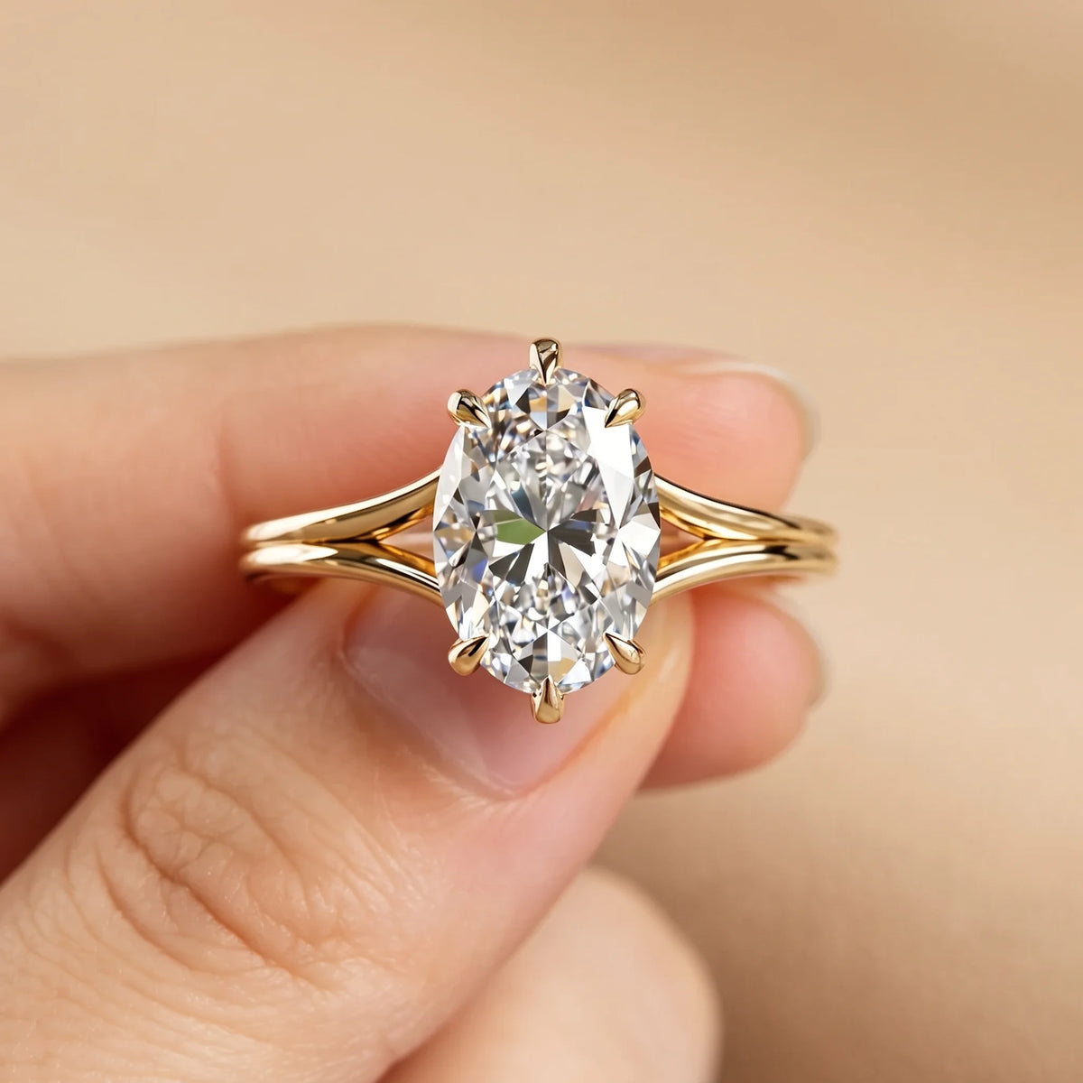 4.5ct oval moissanite split shank engagement ring held between the fingers showing the six prong setting - Sensitive Stones