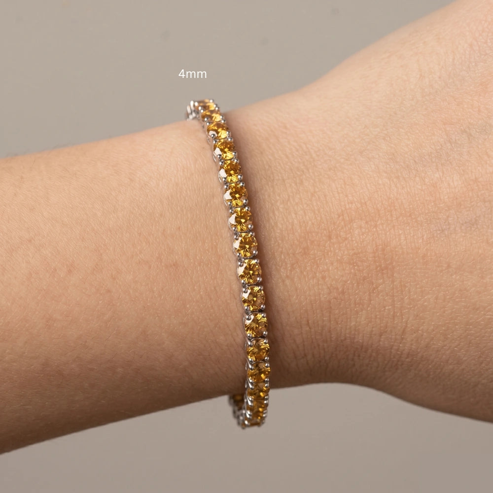 4mm Citrine yellow moissanite tennis bracelet worn on wrist with cream sweater, 925 sterling silver, natural lighting - Sensitive Stones
