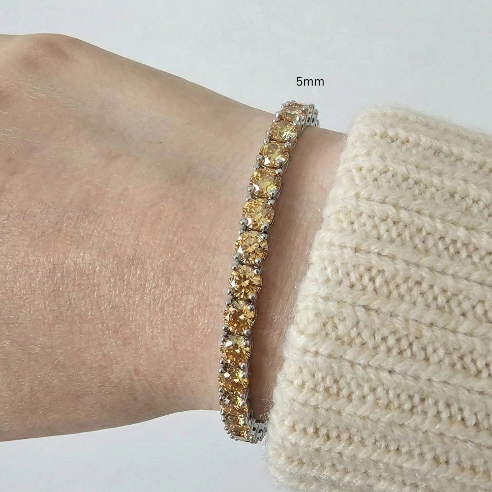 5mm Citrine yellow moissanite tennis bracelet worn on wrist with cream sweater, 925 sterling silver, natural lighting - Sensitive Stones