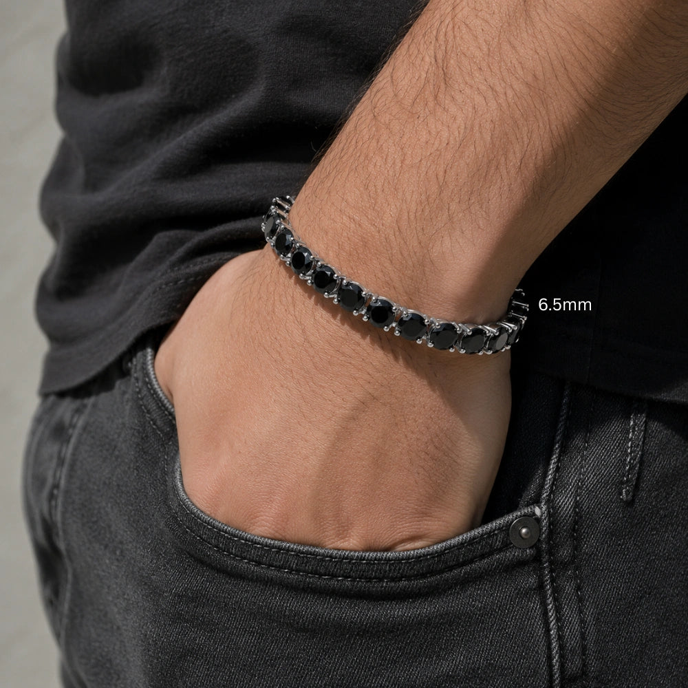 6.5mm black moissanite tennis bracelet in white gold plating, men’s wrist in black simple t-shirt with hand in pocket modern casual style – Sensitive Stones