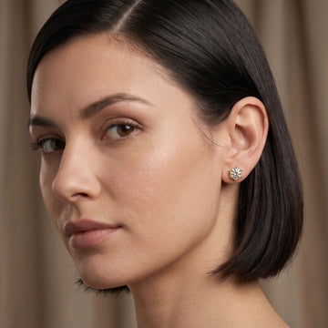 Woman with a dark bob wearing a 6-prong moissanite solitaire stud earring in 14K yellow gold filled - Sensitive Stones