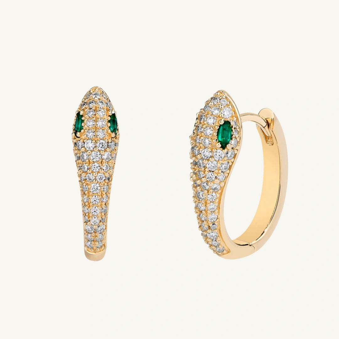Moissanite snake hoop earrings with lab emerald accents on a beige background - Sensitive Stones