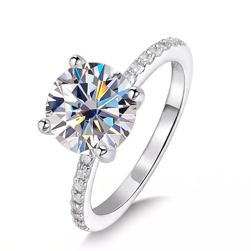 Angled view of the D Color moissanite engagement ring with a solitaire center stone above a 5A cubic zirconia pave band - Sensitive Stones