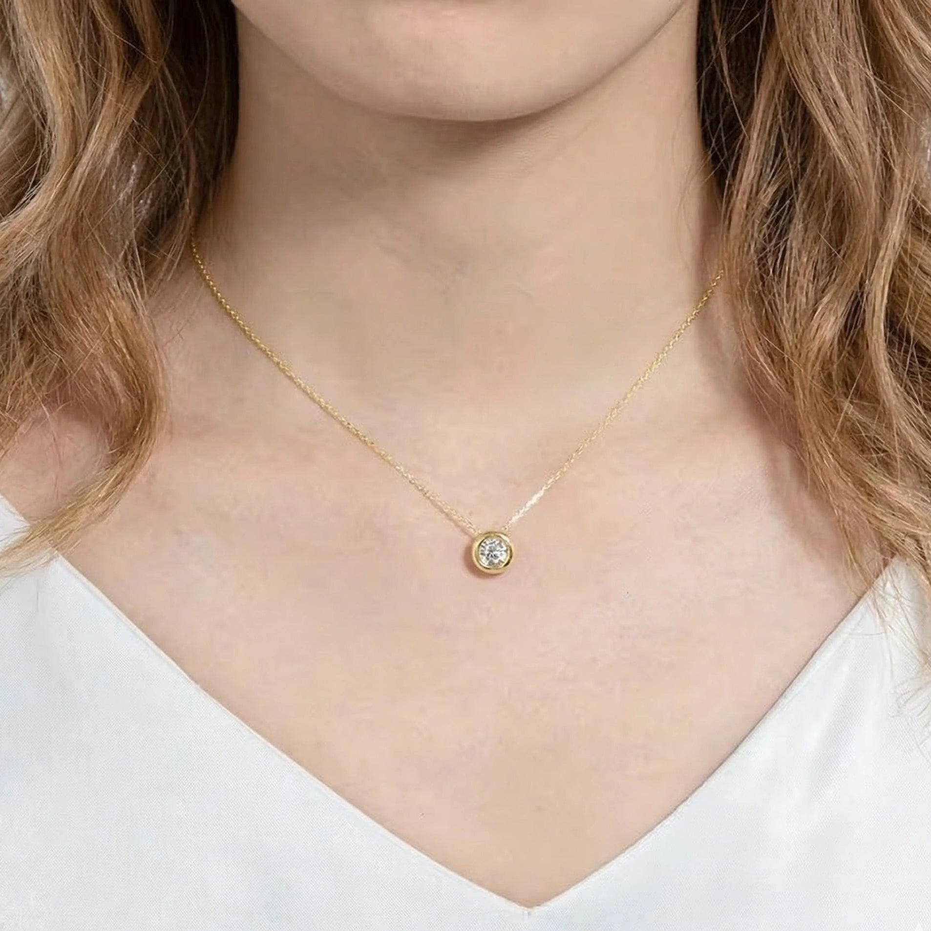 Woman wearing 1ct bezel moissanite pendant necklace in 18K gold plating on delicate O-chain - Sensitive Stones