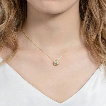 Woman wearing 1ct bezel moissanite pendant necklace in 18K gold plating on delicate O-chain - Sensitive Stones