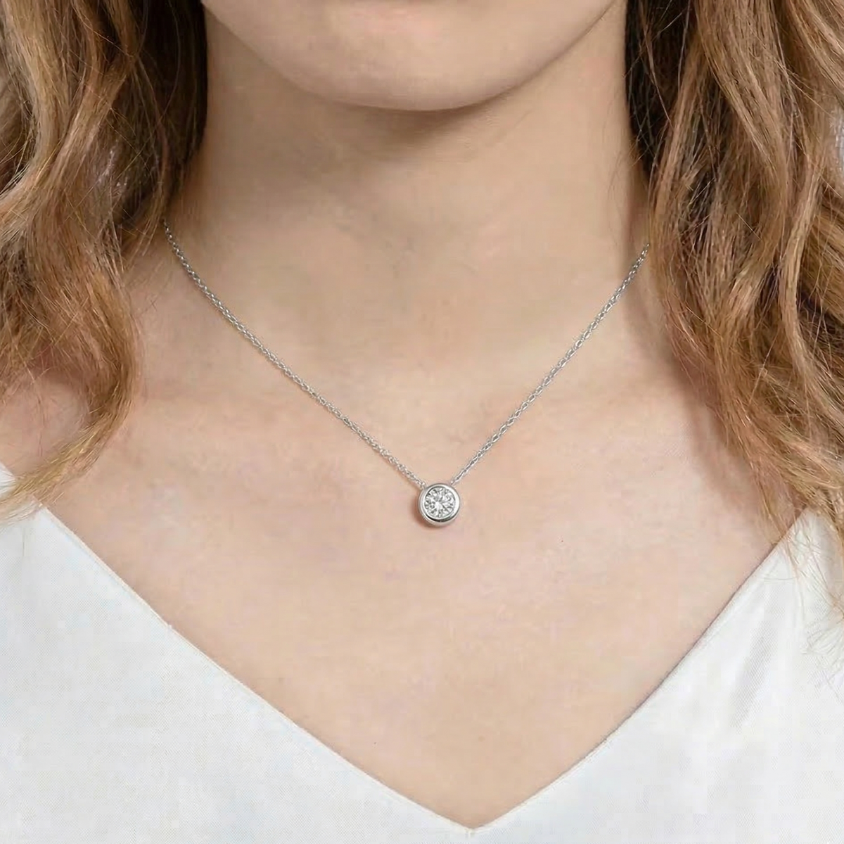 Woman wearing 1ct bezel moissanite pendant necklace in 925 sterling silver on delicate O-chain - Sensitive Stones