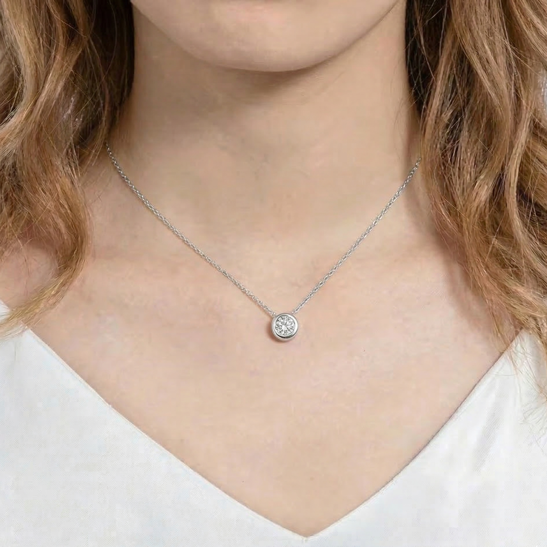 Woman wearing 1ct bezel moissanite pendant necklace in 925 sterling silver on delicate O-chain - Sensitive Stones