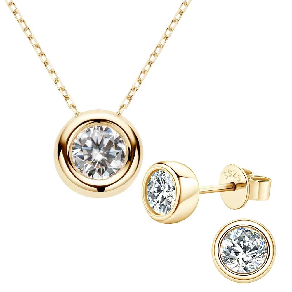 Set of 1ct Bezel moissanite necklace and 1ct stud earrings pair in 14K gold plating styled on green background - Sensitive Stones