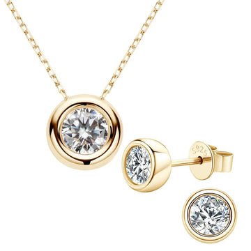 Set of 1ct Bezel moissanite necklace and 1ct stud earrings pair in 14K gold plating styled on green background - Sensitive Stones