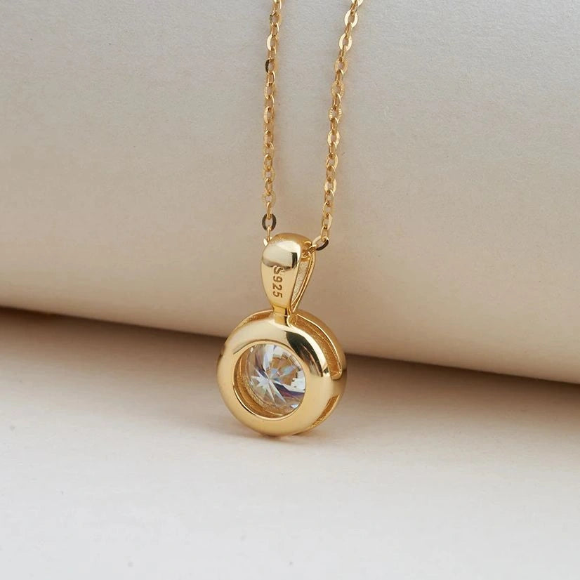 Bezel set round moissanite pendant close up in 925 sterling silver - Sensitive Stones