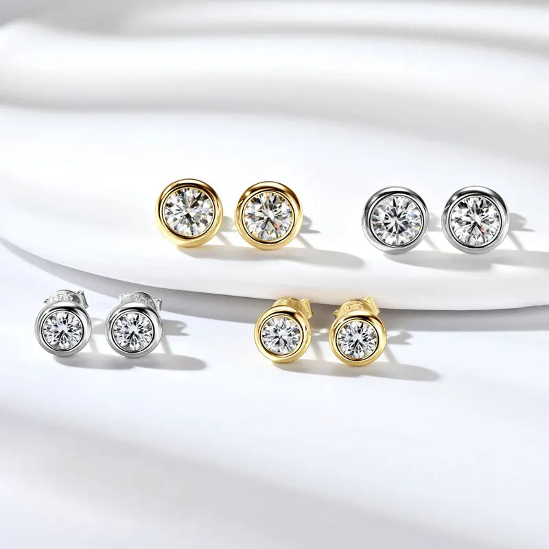 Bezel set moissanite stud earrings shown in both white gold and yellow gold finishes side by side - Sensitive Stones