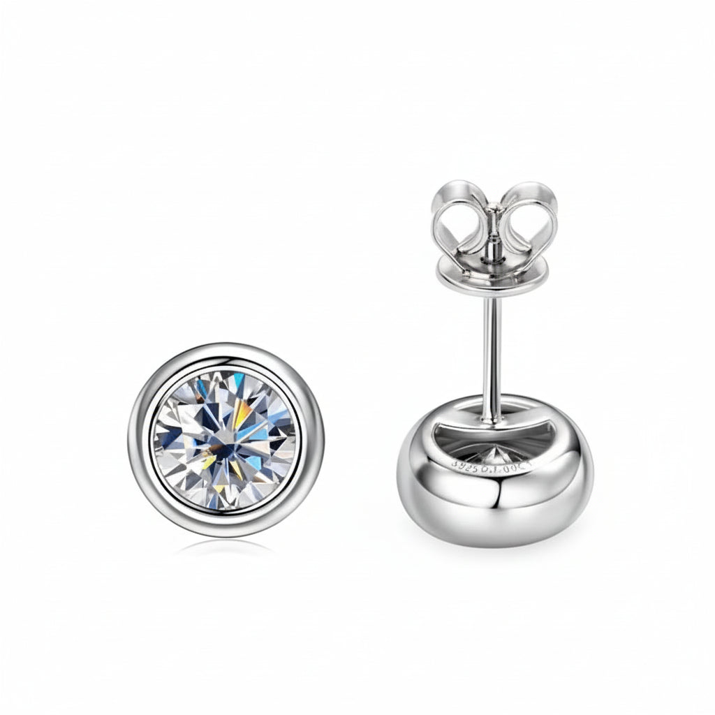 Bezel set moissanite stud earrings in 925 sterling silver with a white gold finish showing the front face and butterfly back - Sensitive Stones
