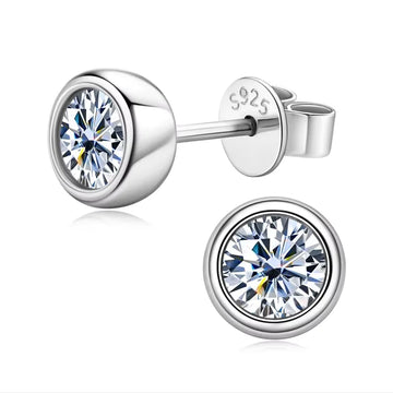Bezel set moissanite stud earrings in 925 sterling silver with a white gold finish showing side profile and top view with the S925 hallmark - Sensitive Stones