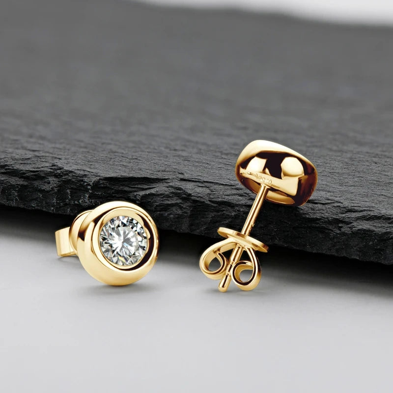 Bezel set moissanite stud earrings in 925 sterling silver with a yellow gold finish showing the front face and butterfly back - Sensitive Stones